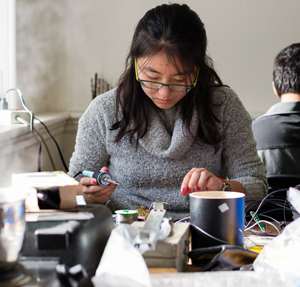 Woman soldering in Kings Court English